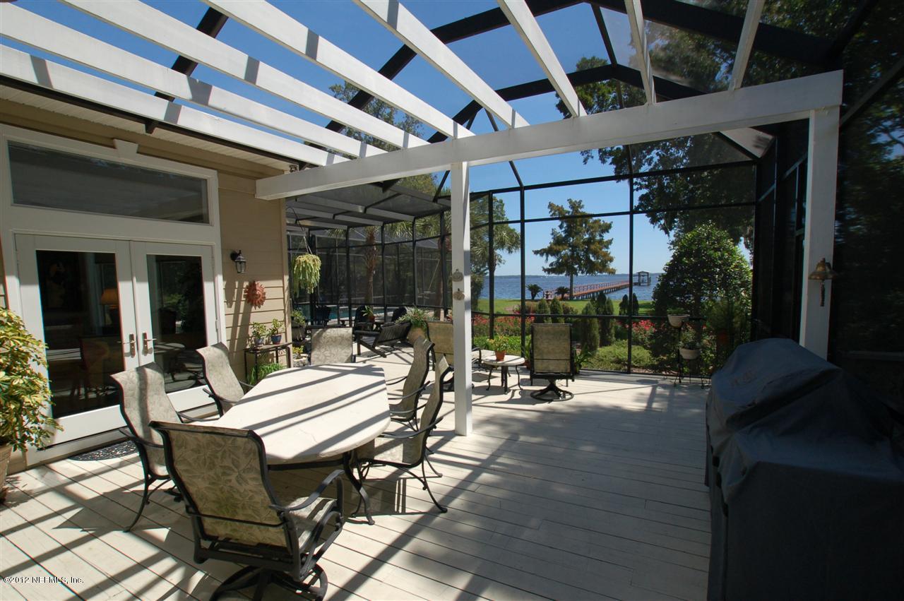 4665 Raggedy Point Road Fleming Island, FL 32003 - Photo 39 of 85 a view of a patio with table and chairs and potted plants