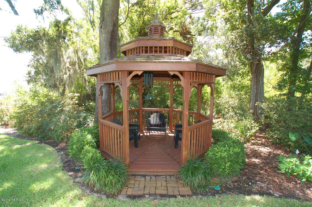 4665 Raggedy Point Road Fleming Island, FL 32003 - Photo 45 of 85 a view of a wooden deck with a yard