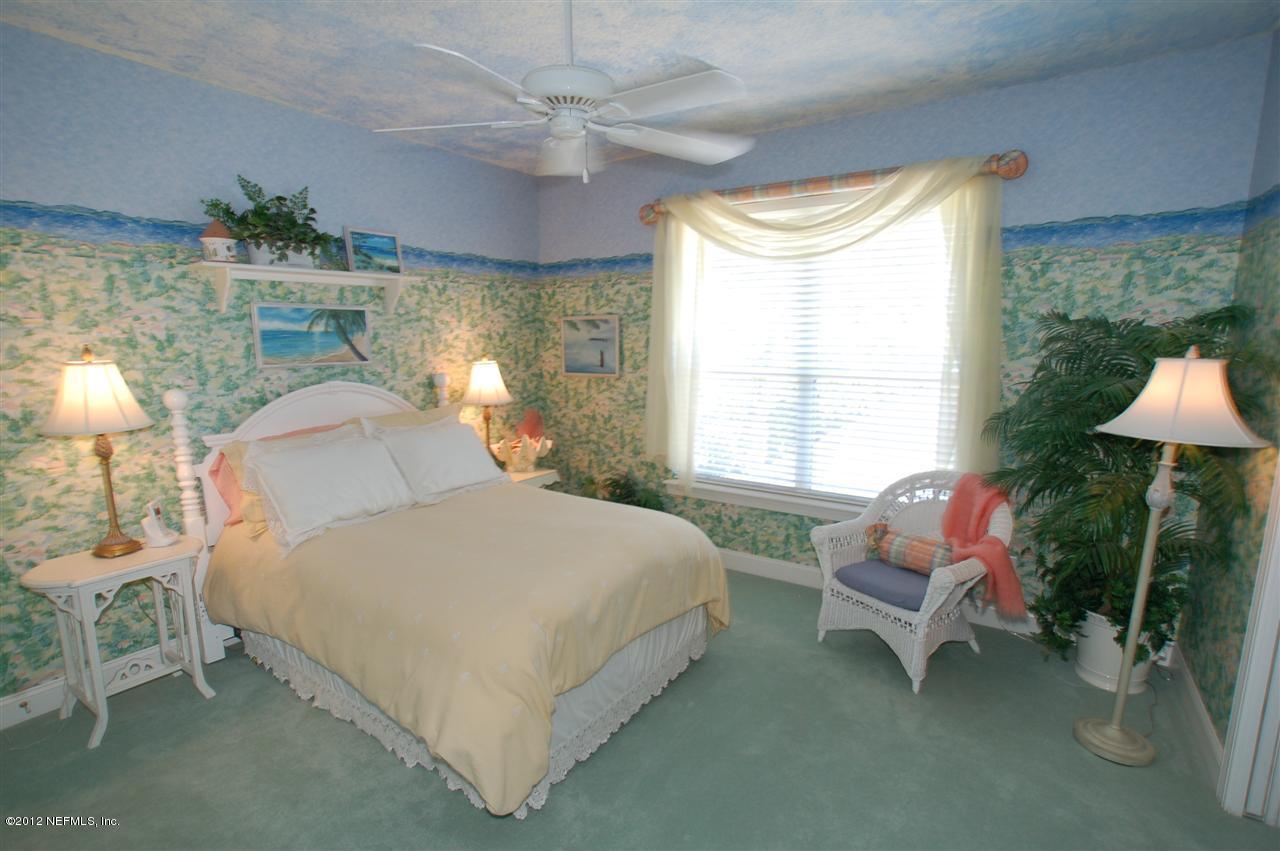 4665 Raggedy Point Road Fleming Island, FL 32003 - Photo 50 of 85 a bedroom with a bed chair and table