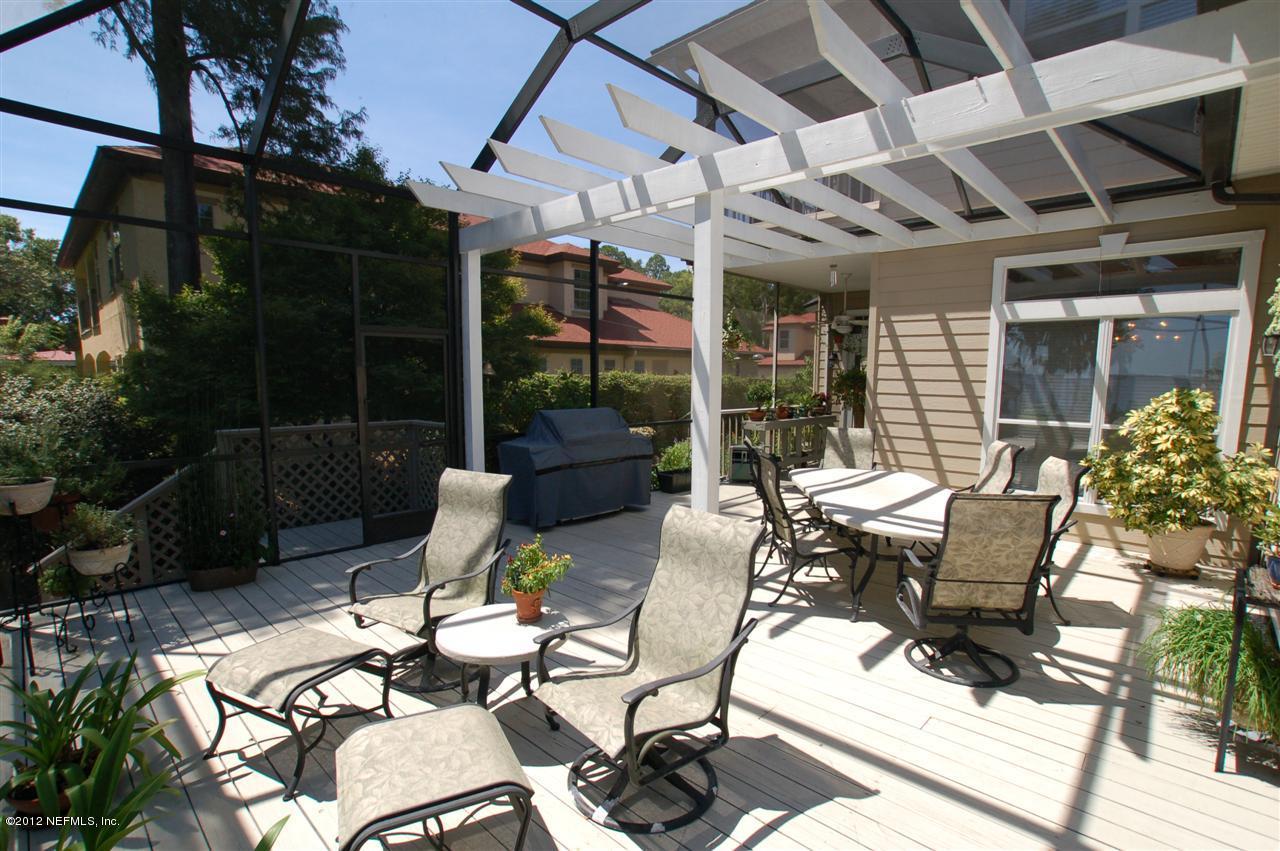 4665 Raggedy Point Road Fleming Island, FL 32003 - Photo 53 of 85 a view of a patio with chairs and table in patio