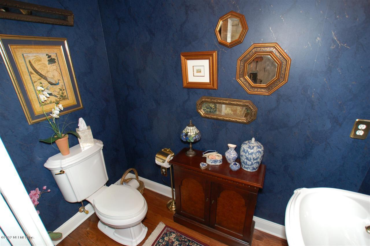 4665 Raggedy Point Road Fleming Island, FL 32003 - Photo 6 of 85 a bathroom with a toilet and a wooden floor