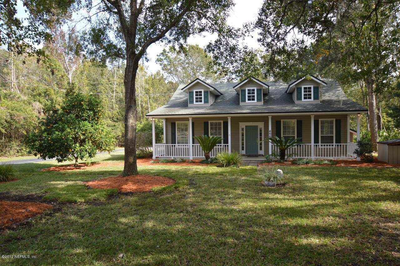 4665 Raggedy Point Road Fleming Island, FL 32003 - Photo 61 of 85 a front view of a house with a garden