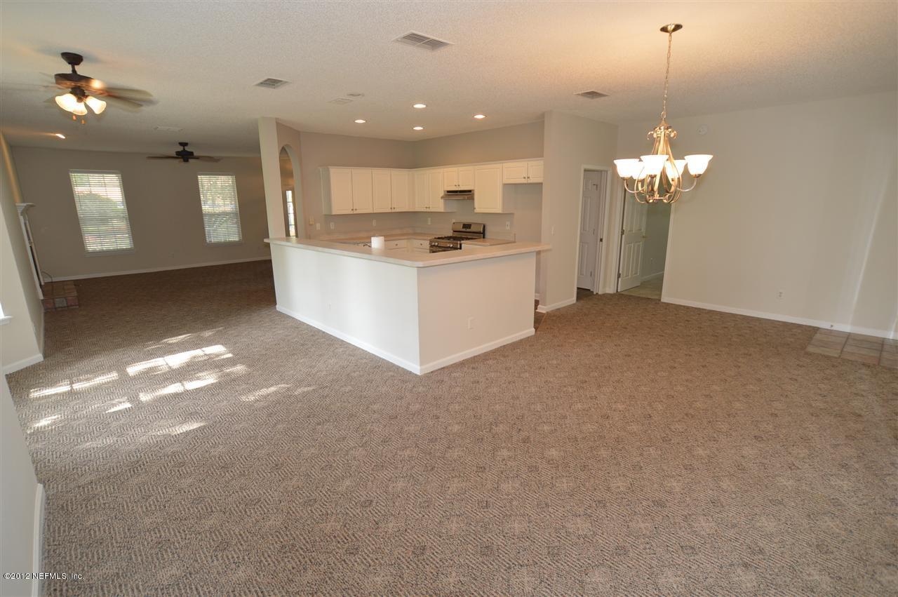 4665 Raggedy Point Road Fleming Island, FL 32003 - Photo 64 of 85 a view of a kitchen with granite countertop natural light and stainless steel appliances