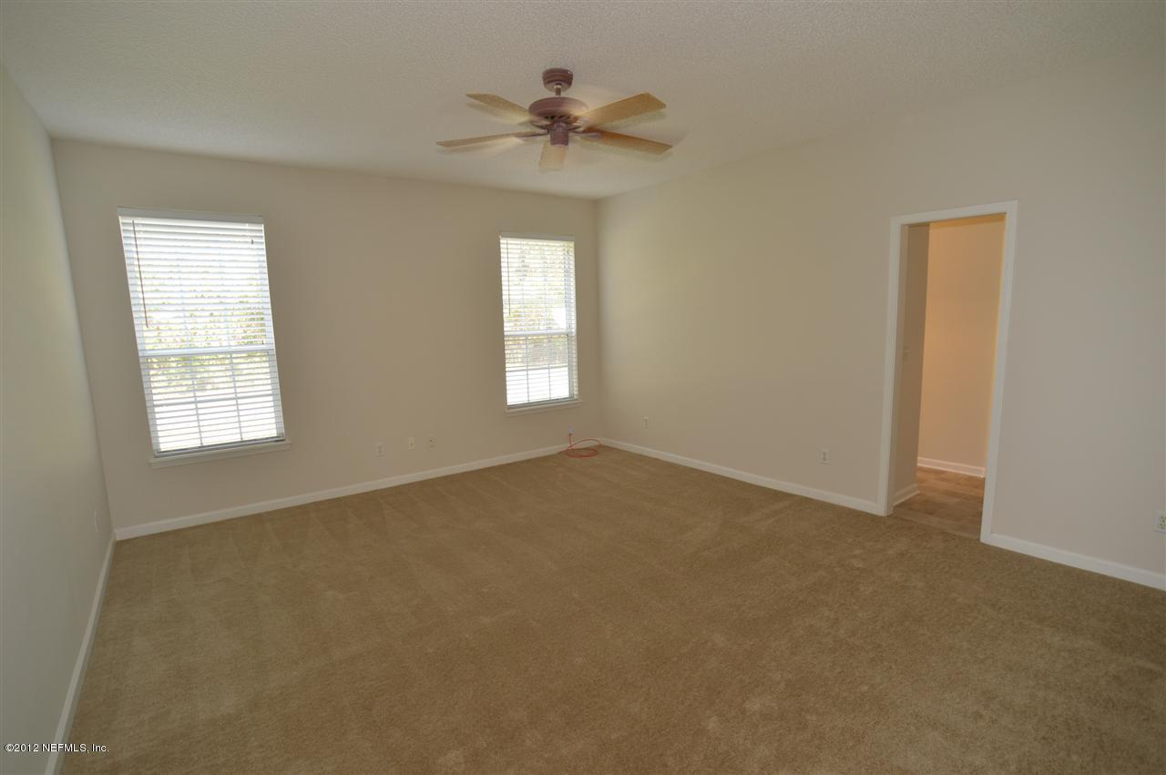 4665 Raggedy Point Road Fleming Island, FL 32003 - Photo 70 of 85 an empty room with a window and a chandelier fan