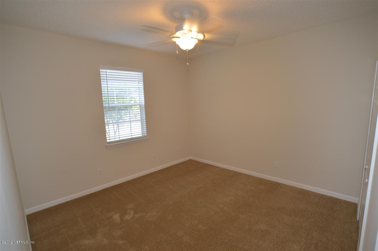4665 Raggedy Point Road Fleming Island, FL 32003 - Photo 76 of 85 an empty room with a window and a fan