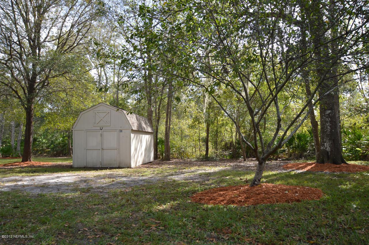 4665 Raggedy Point Road Fleming Island, FL 32003 - Photo 80 of 85 a backyard of a house with trees and entertaining space