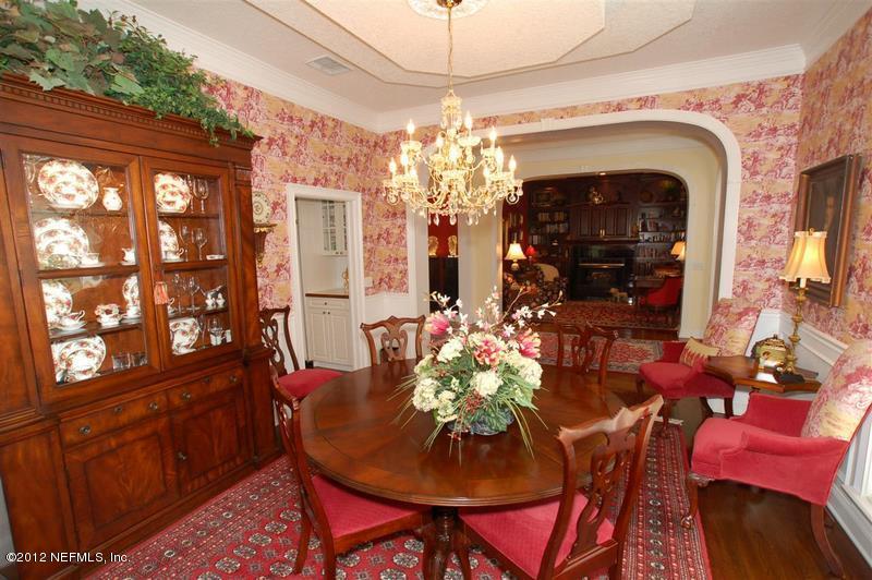 4665 Raggedy Point Road Fleming Island, FL 32003 - Photo 8 of 85 a view of a dining room with furniture and chandelier