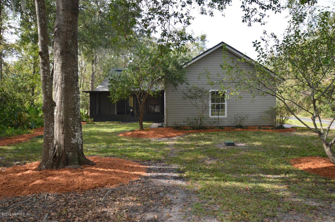 4665 Raggedy Point Road Fleming Island, FL 32003 - Photo 85 of 85 a backyard of a house with large trees and wooden fence