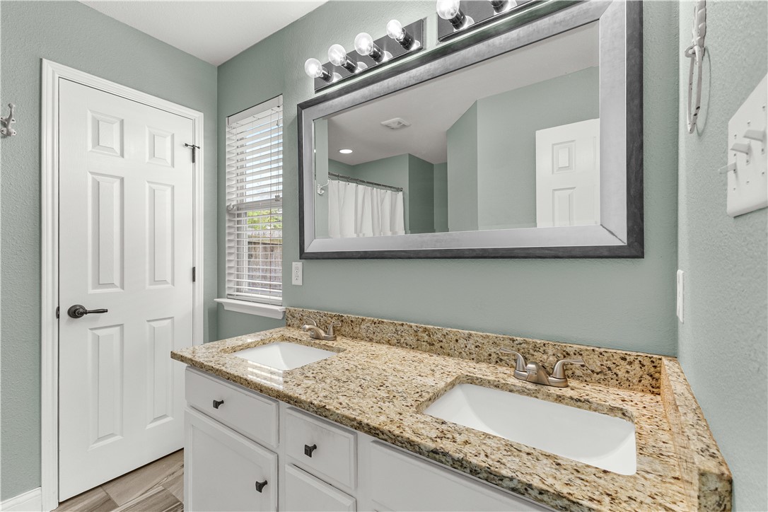 3709 Springfield Drive College Station, TX 77845 - Photo 12 of 23 a bathroom with a granite countertop sink and a mirror