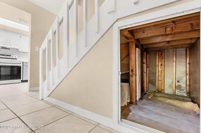 a view of an entryway with wooden floor and livingroom