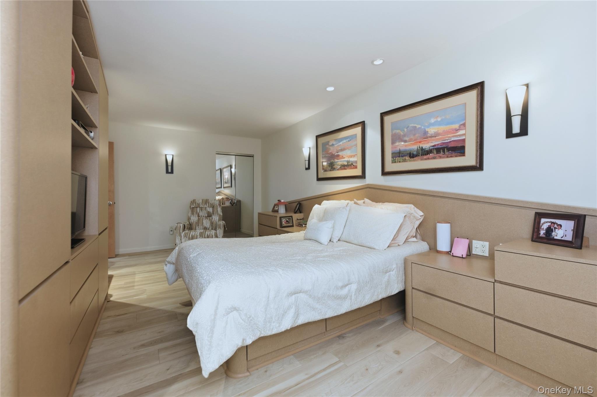 522 Shore Road, Unit 2AA Long Beach, NY 11561 - Photo 14 of 32 a bedroom with a bed and a flat screen tv