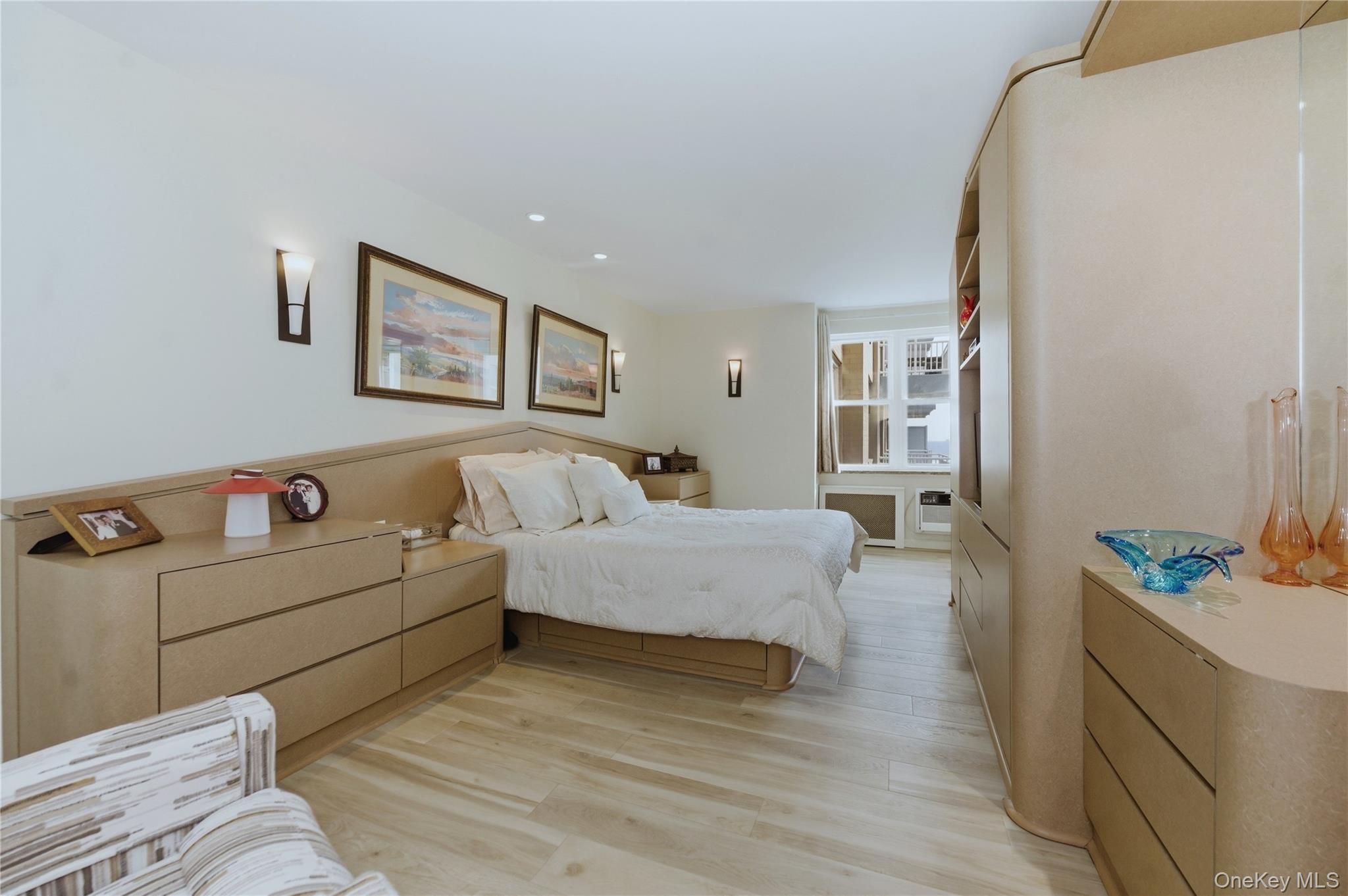 522 Shore Road, Unit 2AA Long Beach, NY 11561 - Photo 15 of 32 a spacious bedroom with a bed and a couch