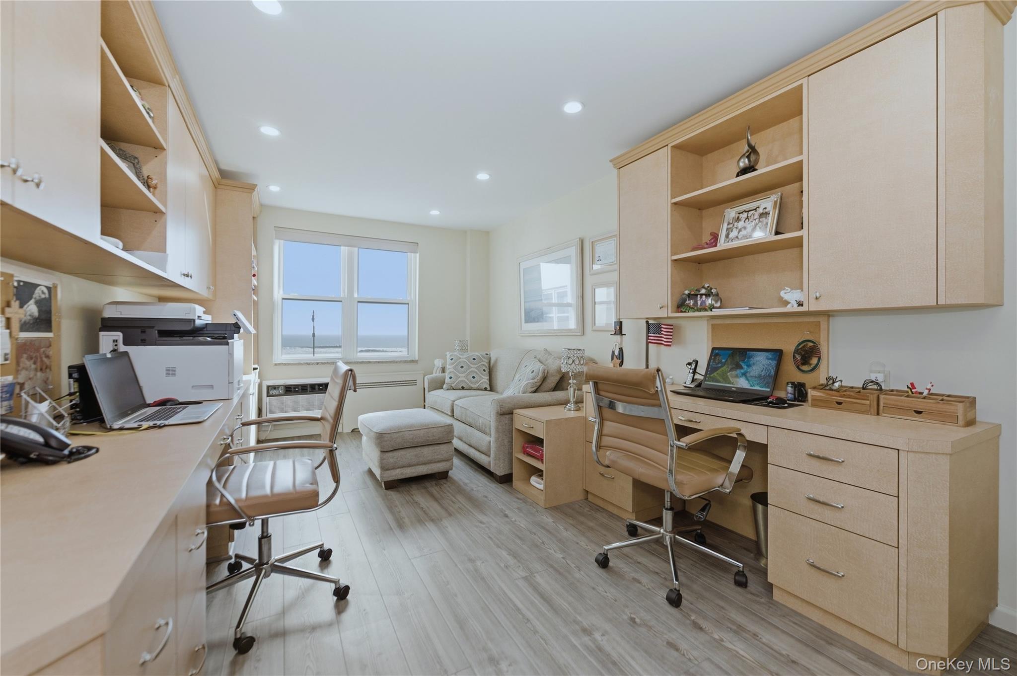 522 Shore Road, Unit 2AA Long Beach, NY 11561 - Photo 16 of 32 a work room with furniture a flat screen tv and gym equipment