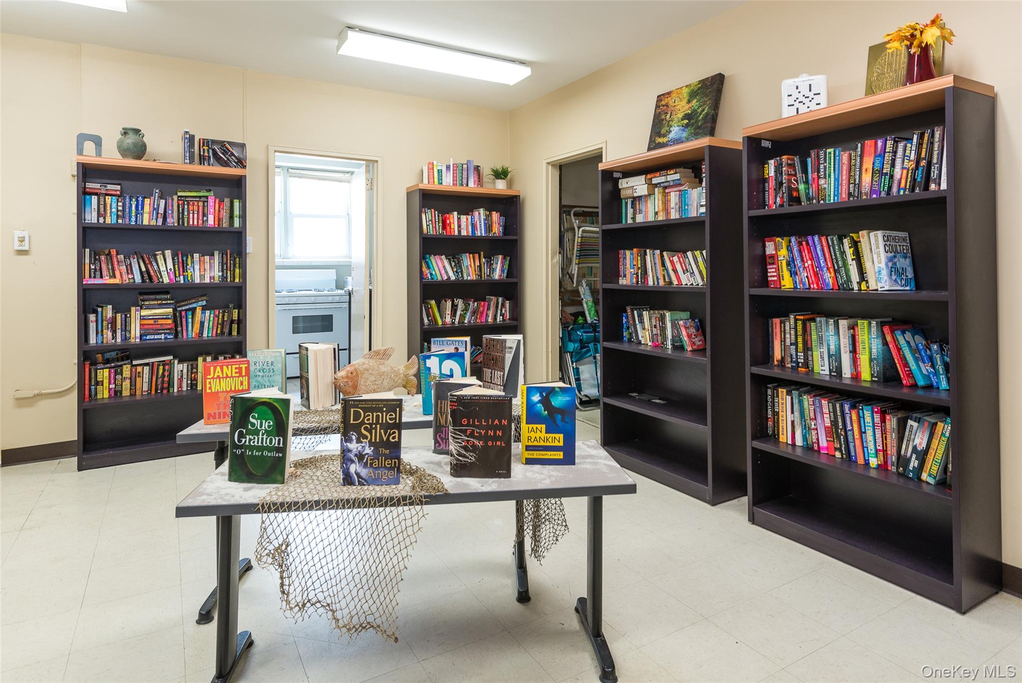 522 Shore Road, Unit 2AA Long Beach, NY 11561 - Photo 26 of 32 a living room with a book shelf and a shelf