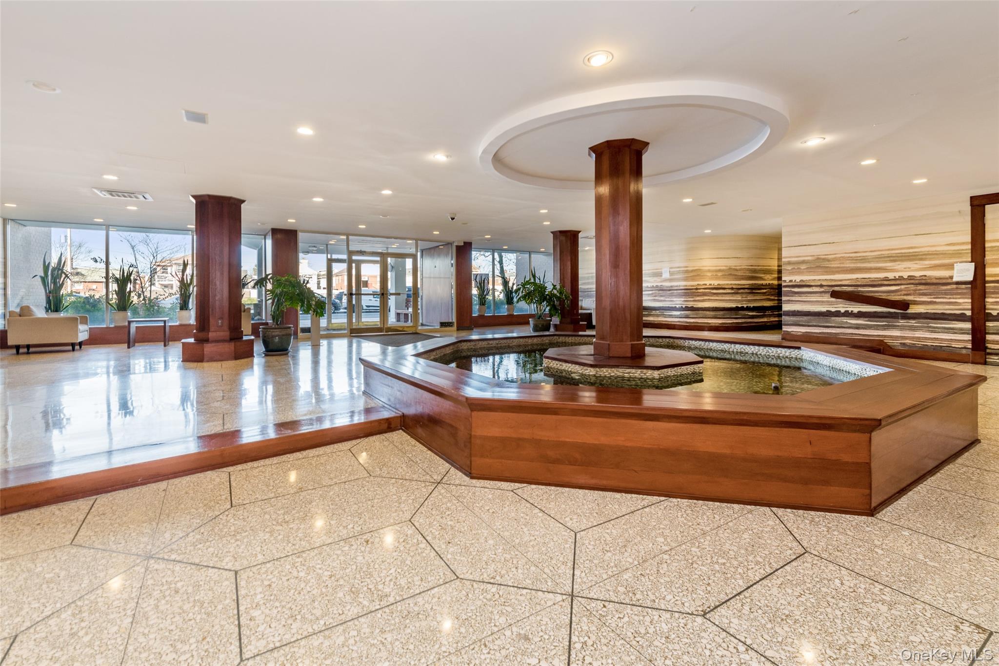 522 Shore Road, Unit 2AA Long Beach, NY 11561 - Photo 4 of 32 a view of a kitchen with granite countertop a couch and a view of living room