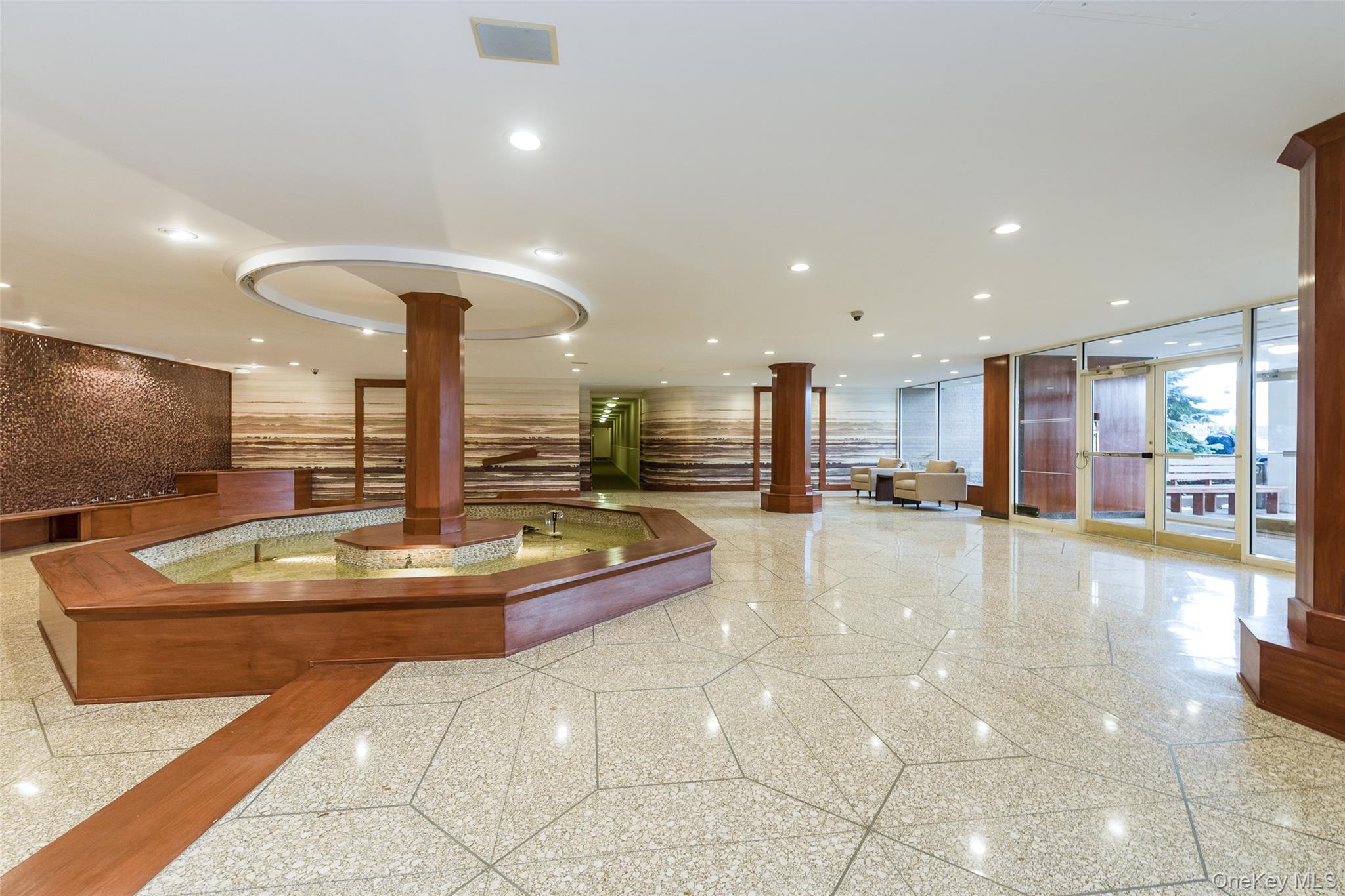 522 Shore Road, Unit 2AA Long Beach, NY 11561 - Photo 5 of 32 a lobby with a table and chairs