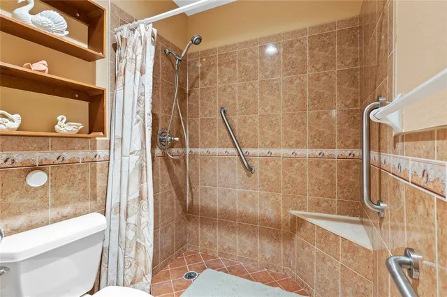 a bathroom with a shower and a toilet
