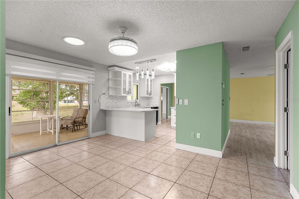 8470 Southwest 107th Place Ocala, FL 34481 - Photo 12 of 44 a view of a kitchen with furniture and a large window