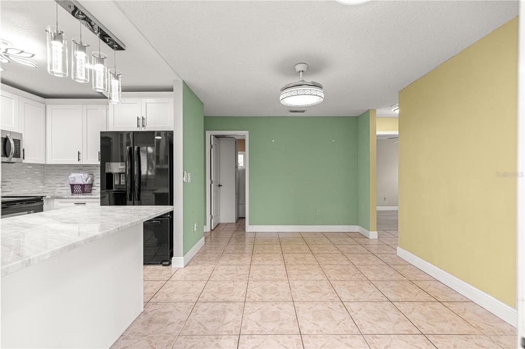 8470 Southwest 107th Place Ocala, FL 34481 - Photo 13 of 44 a view of a kitchen with a sink and a refrigerator