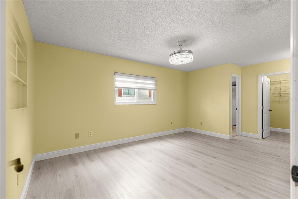 8470 Southwest 107th Place Ocala, FL 34481 - Photo 18 of 44 a view of an empty room with wooden floor and a window