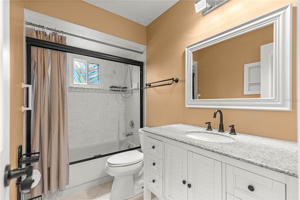 8470 Southwest 107th Place Ocala, FL 34481 - Photo 24 of 44 a bathroom with a granite countertop toilet sink and a mirror