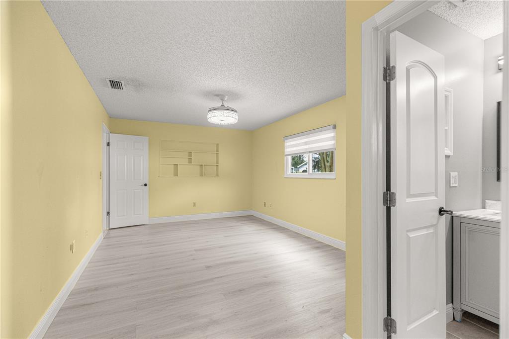 8470 Southwest 107th Place Ocala, FL 34481 - Photo 25 of 44 a view of a big room with wooden floor and windows