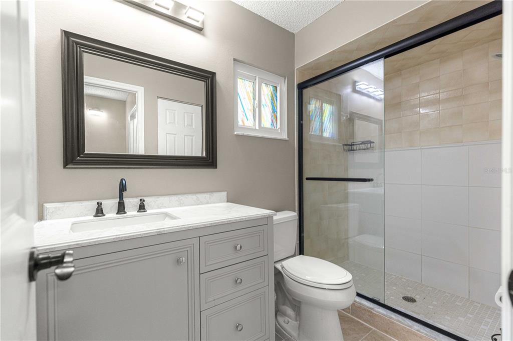 8470 Southwest 107th Place Ocala, FL 34481 - Photo 26 of 44 a bathroom with a toilet sink vanity and mirror