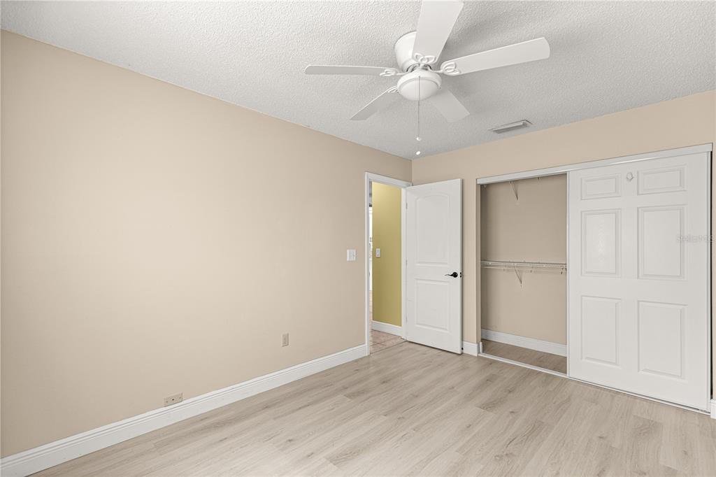 8470 Southwest 107th Place Ocala, FL 34481 - Photo 29 of 44 a view of an empty room with wooden floor