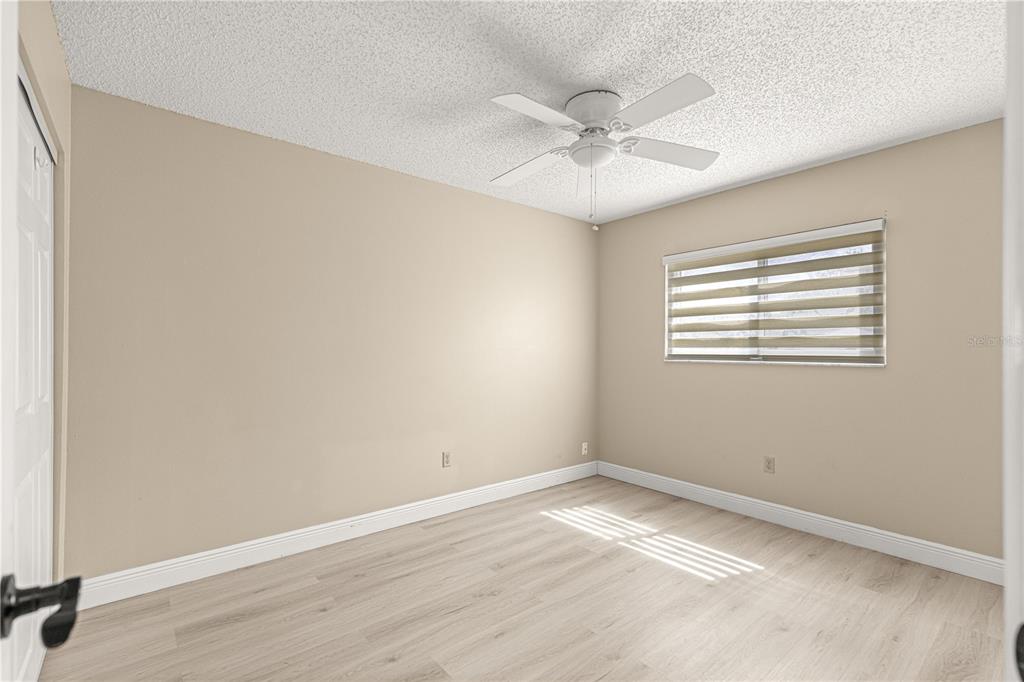 8470 Southwest 107th Place Ocala, FL 34481 - Photo 30 of 44 an empty room with a window and a fan