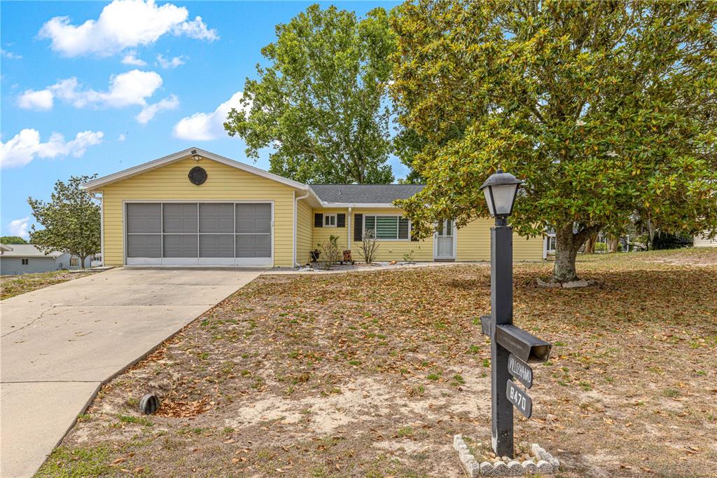 8470 Southwest 107th Place Ocala, FL 34481 - Photo 34 of 44 a front view of a house with garden