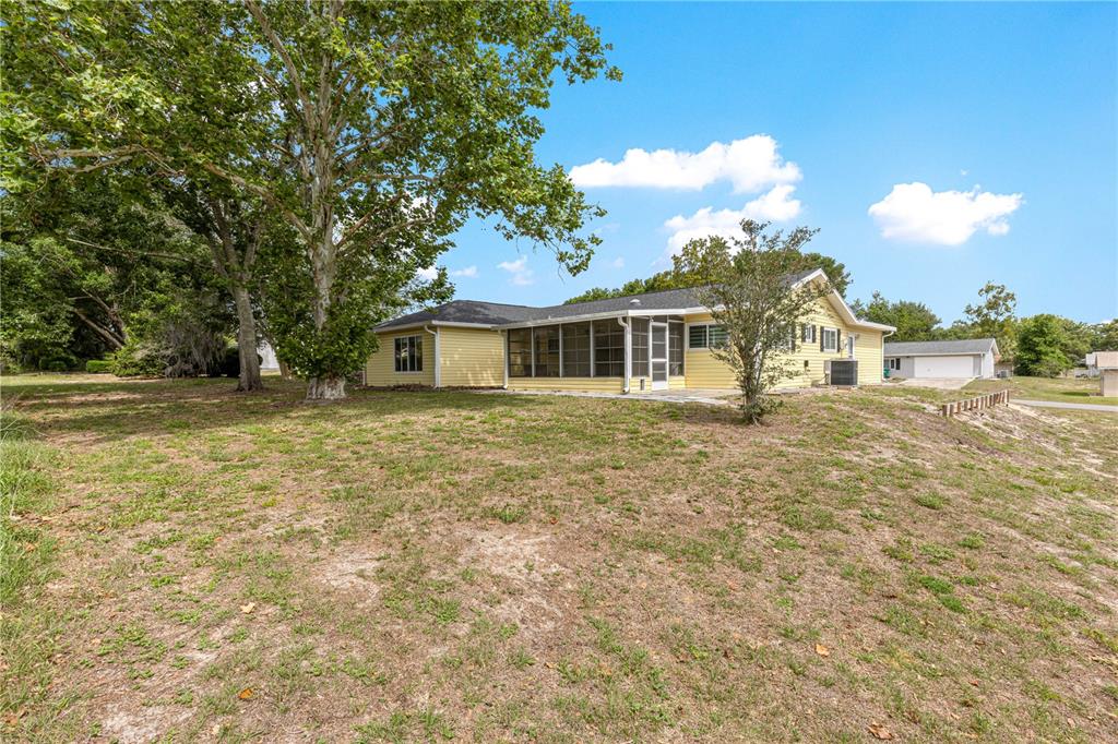 8470 Southwest 107th Place Ocala, FL 34481 - Photo 37 of 44 a front view of a house with a garden