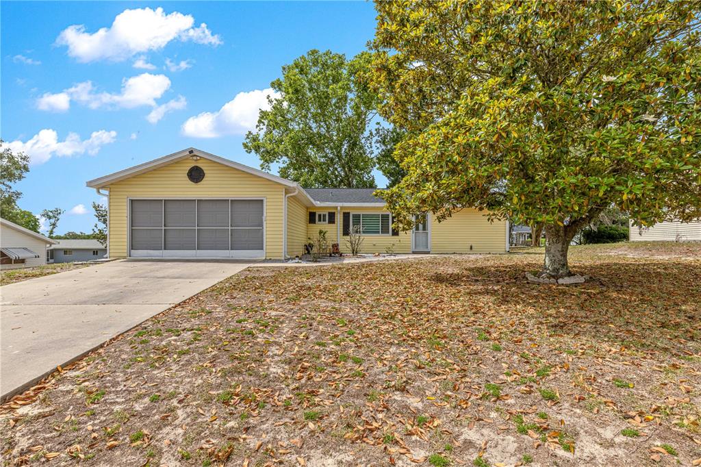 8470 Southwest 107th Place Ocala, FL 34481 - Photo 40 of 44 a front view of a house with a garden