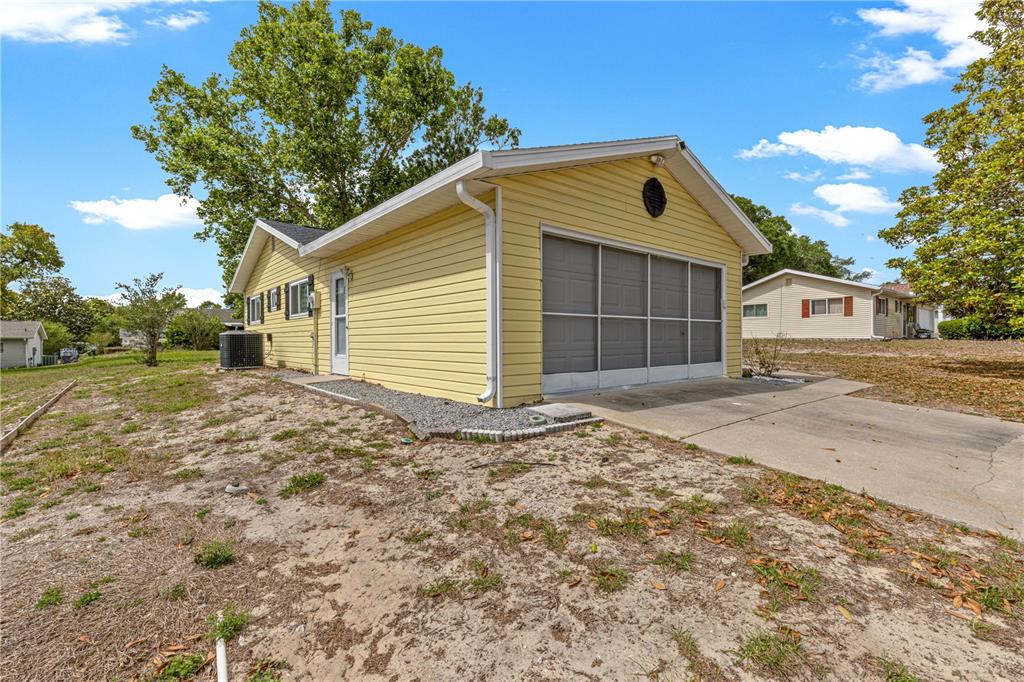 8470 Southwest 107th Place Ocala, FL 34481 - Photo 41 of 44 a front view of a house with a yard and garage