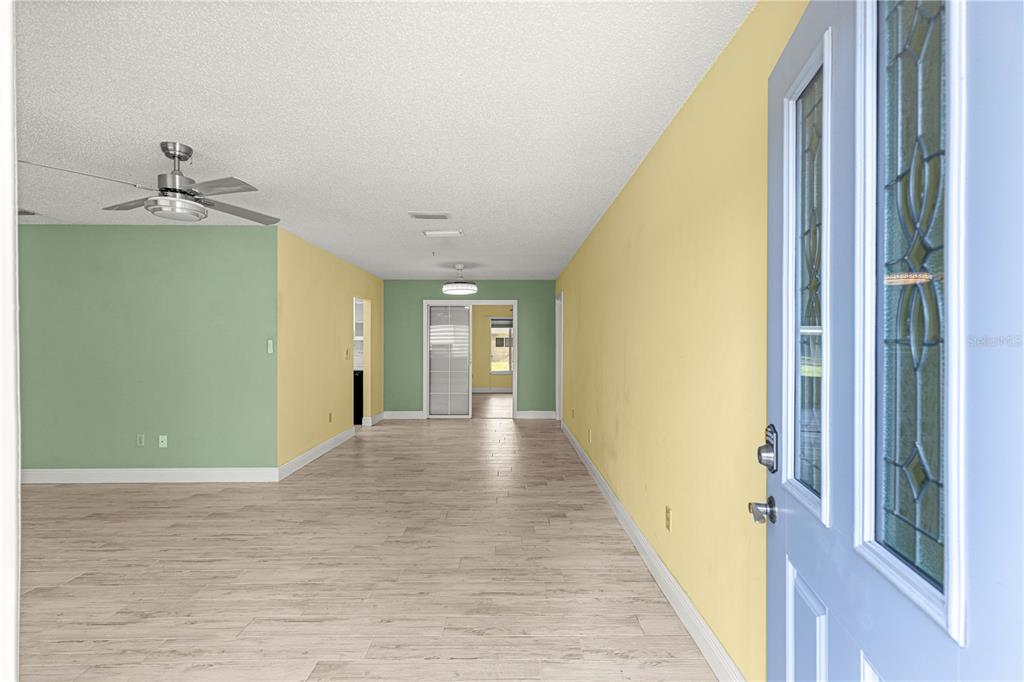 8470 Southwest 107th Place Ocala, FL 34481 - Photo 5 of 44 a view of a hallway with wooden floor and staircase