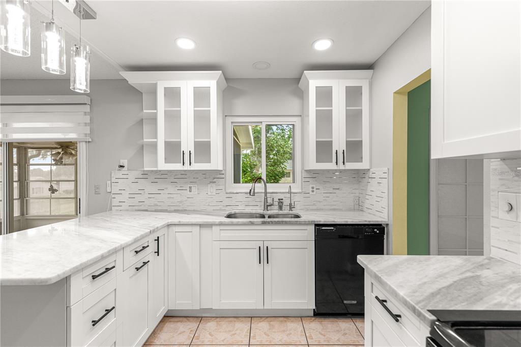 8470 Southwest 107th Place Ocala, FL 34481 - Photo 7 of 44 a kitchen that has a sink and a stove in it
