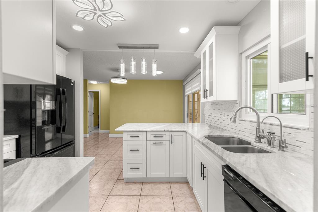 8470 Southwest 107th Place Ocala, FL 34481 - Photo 9 of 44 a kitchen with stainless steel appliances granite countertop a sink a stove and a refrigerator