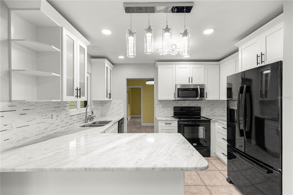 8470 Southwest 107th Place Ocala, FL 34481 - Photo 10 of 44 a kitchen with stainless steel appliances granite countertop a sink refrigerator and cabinets