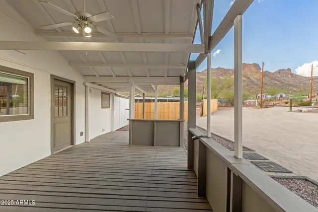 front view of a house with a barbeque and trees