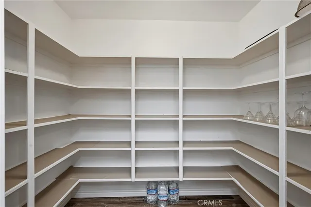 a kitchen with a sink a counter top space stainless steel appliances and cabinets