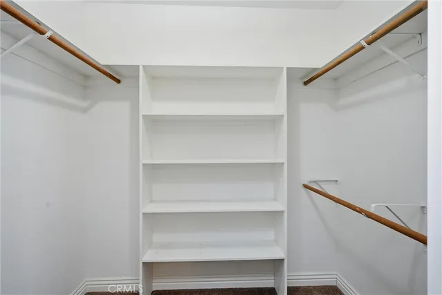 a spacious bathroom with a double vanity sink a mirror and a bathtub