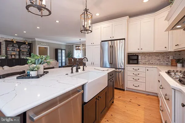 a living room with furniture and view of kitchen