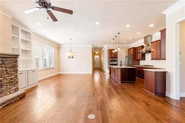 a view of kitchen with sink and refrigerator