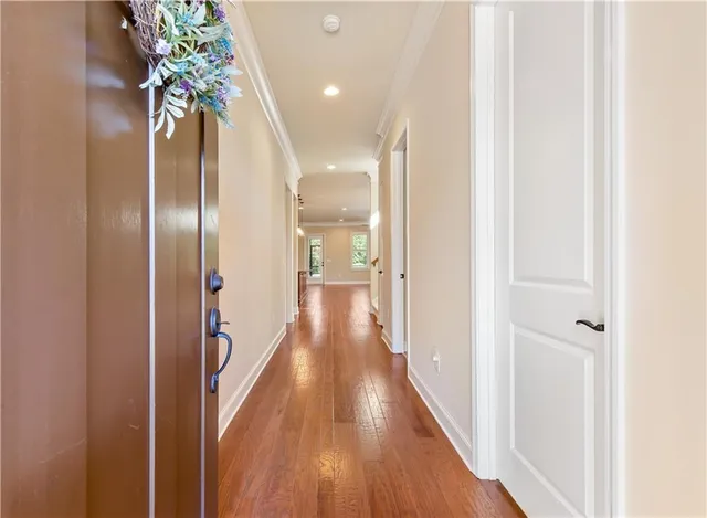 a view of a hallway with wooden floor