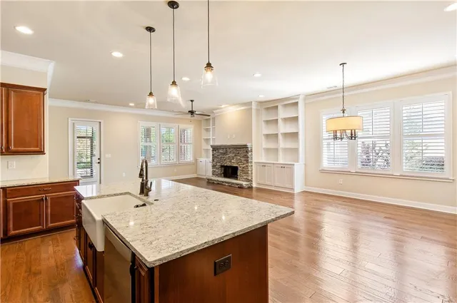 a kitchen with kitchen island a sink stove and wooden floor