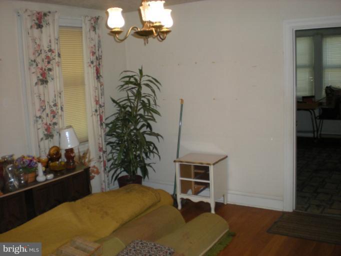 1233 Greystone Road Halethorpe, MD 21227 - Photo 25 of 30 a bedroom with a bed and a potted plant