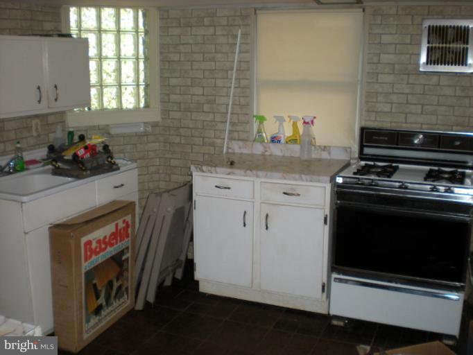 1233 Greystone Road Halethorpe, MD 21227 - Photo 10 of 30 a kitchen with stainless steel appliances a stove a sink and a microwave