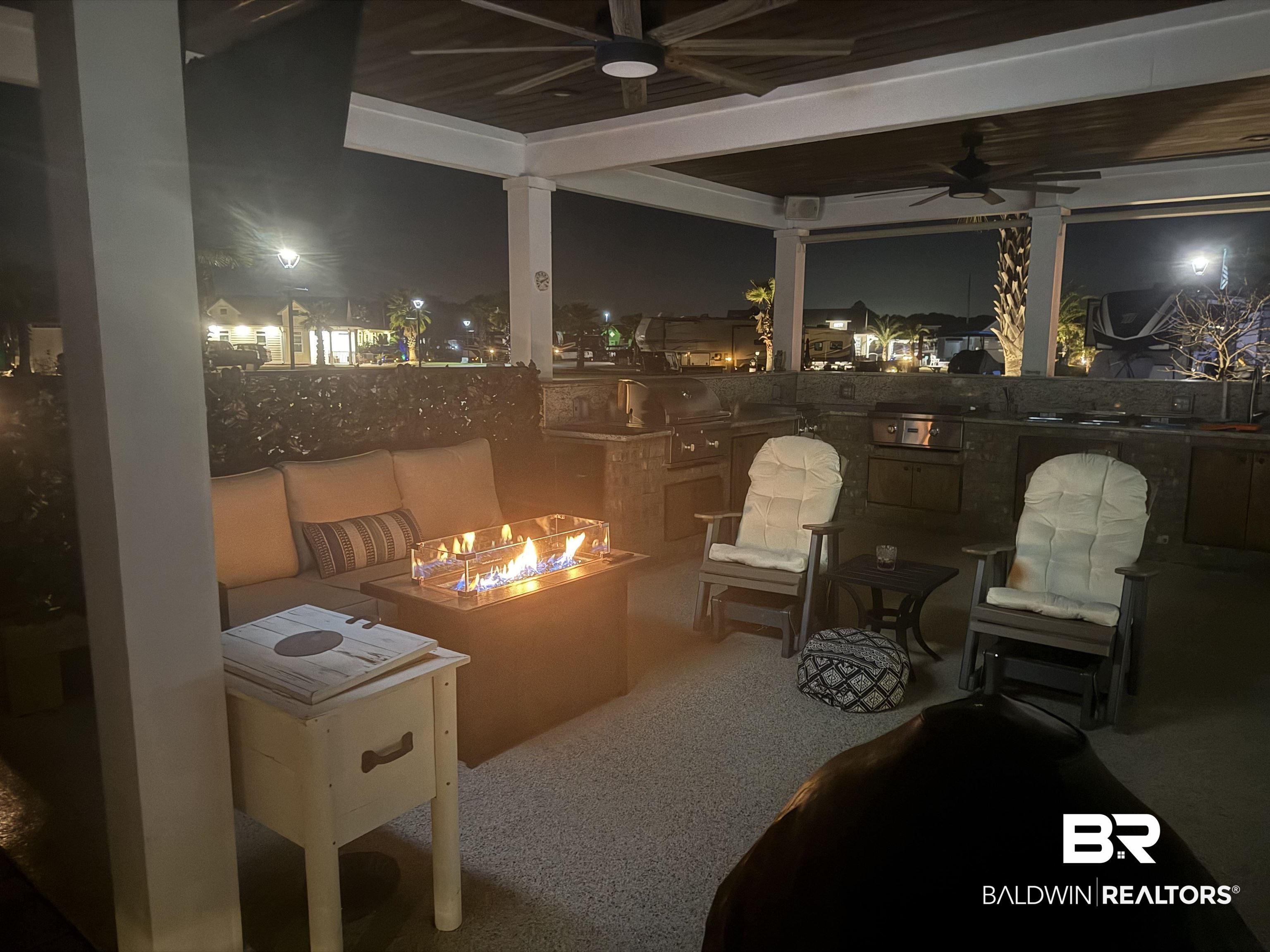 28238 Migratory Way Elberta, AL 36530 - Photo 24 of 58 View of patio with ceiling fan, an outdoor fire pit, and grilling area
