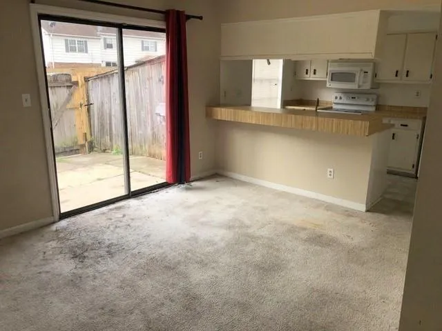 a view of a kitchen with large windows