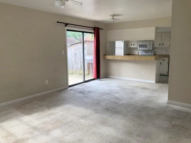 a view of kitchen with refrigerator and window