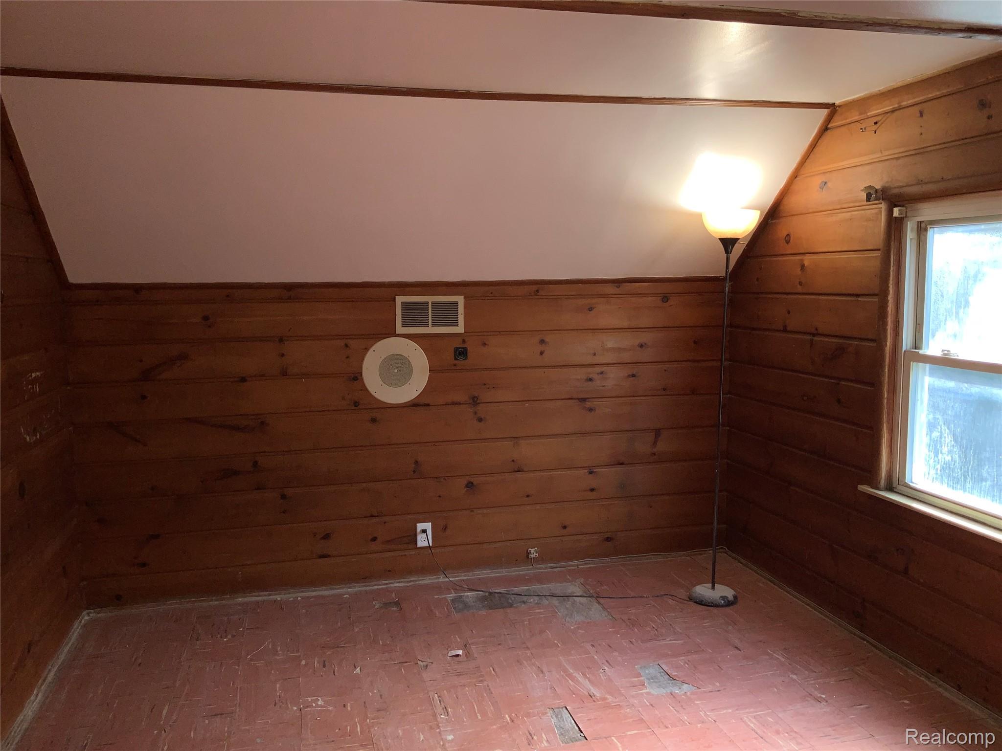 4034 Fleming Road Flint, MI 48504 - Photo 19 of 20 Wood paneling walls, sloped ceiling, single-pane window, wall-mounted speaker